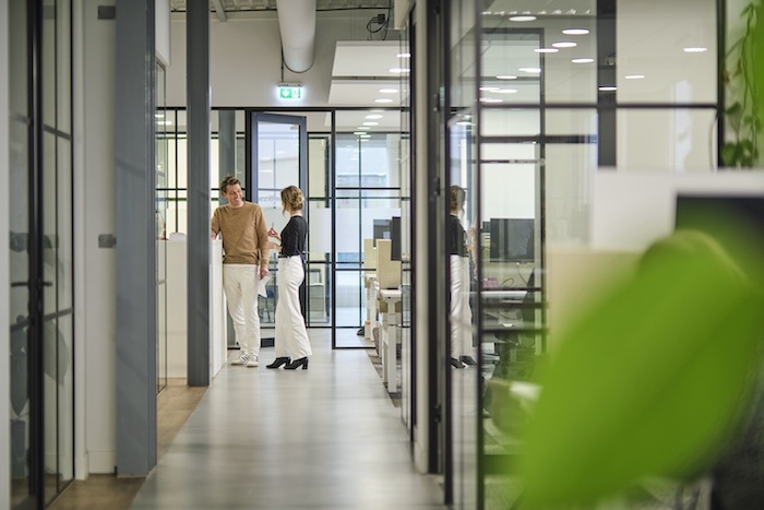 Two collegeaus in converation at the Fresco Farma office